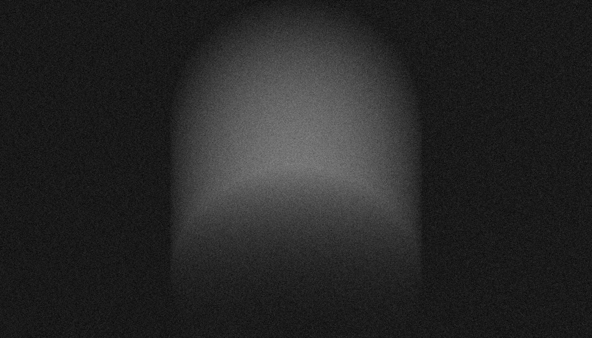 Dimly lit archway with a faint glow